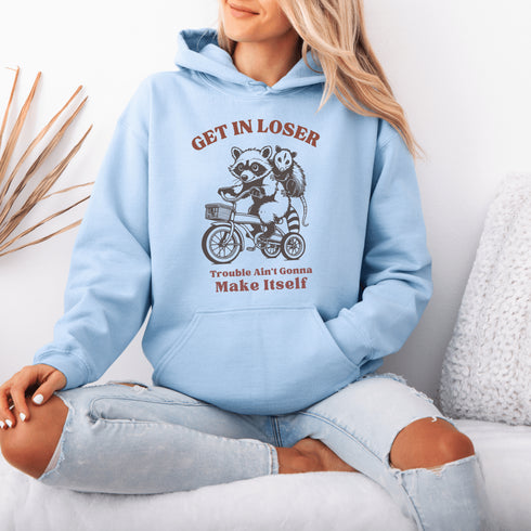 Fuel your wild side with our bold and hilarious hoodie featuring a mischievous raccoon and possum duo cruising on a bike.